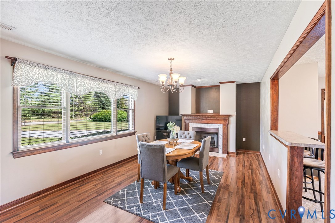 3411 Spring Run Road Mechanicsville, VA 23111 - Photo 6 of 41 a view of a dining room with furniture window and wooden floor