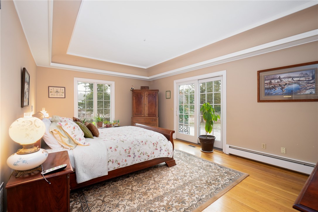 41 Johnson Road Foster, RI 02825 - Photo 22 of 49 Primary master bedroom with tray ceiling and sliders to a private patio