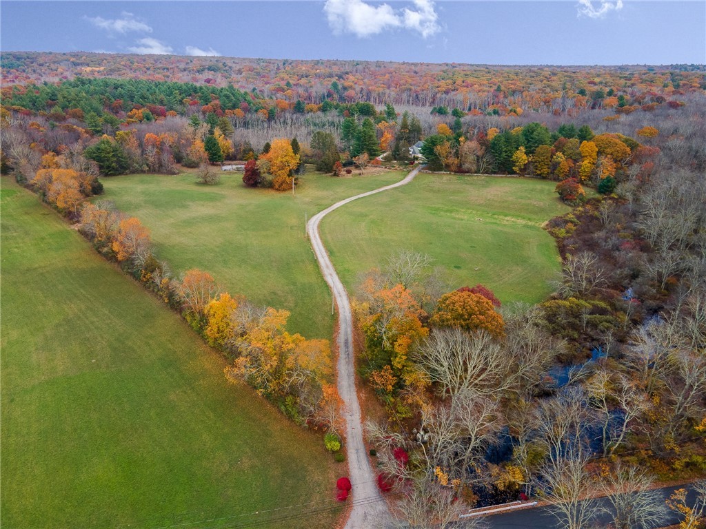 41 Johnson Road Foster, RI 02825 - Photo 4 of 49 A bird's eye view of the long, winding entrance and hayfields on either side, providing plenty of privacy. Meadow Brook on the right forms the southern property line