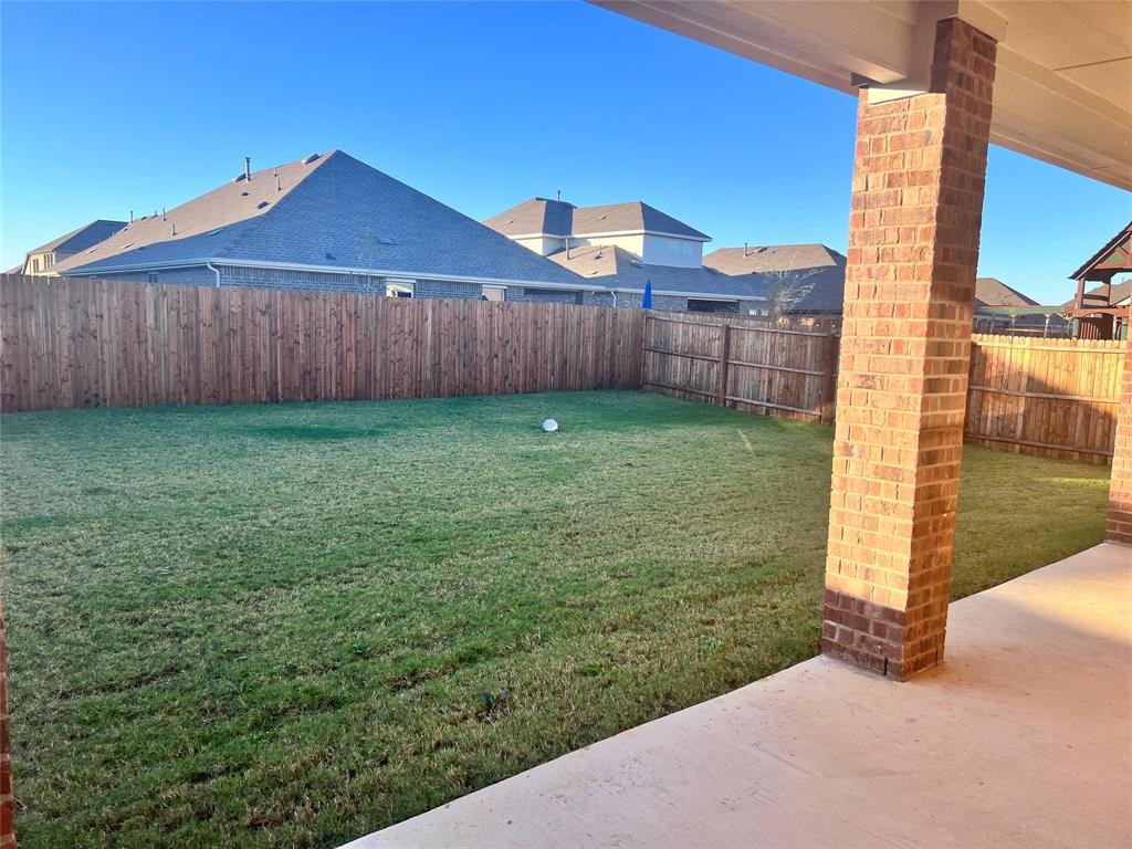 10313 Rambling Brks Lane Aubrey, TX 76227 - Photo 15 of 17 a view of a backyard with wooden fence