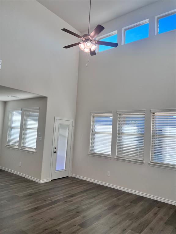 10313 Rambling Brks Lane Aubrey, TX 76227 - Photo 8 of 17 a view of an empty room with wooden floor and a window