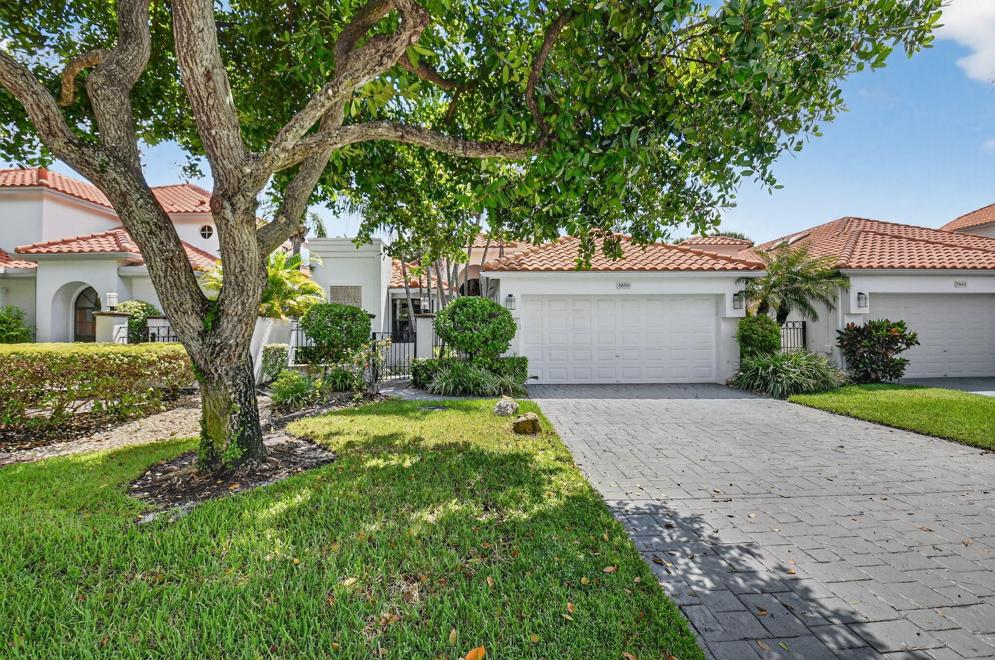5850 Northwest 21st Avenue Boca Raton, FL 33496 - Photo 1 of 54 a front view of a house with garden