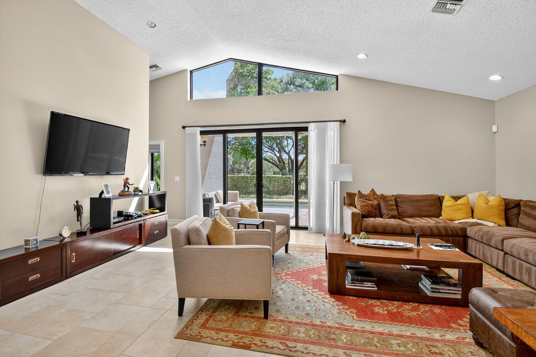 5850 Northwest 21st Avenue Boca Raton, FL 33496 - Photo 11 of 54 a living room with furniture a flat screen tv and a large window