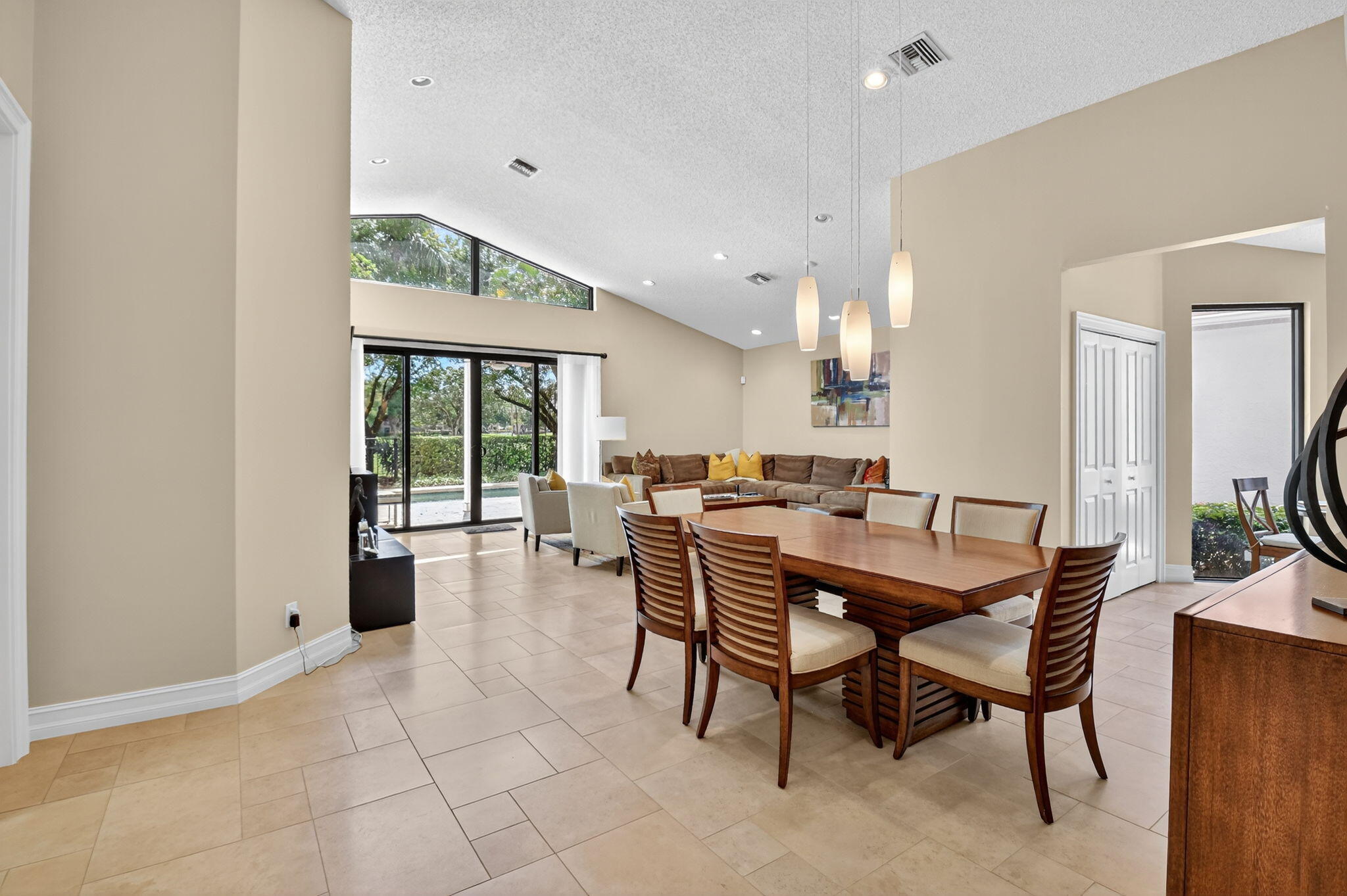 5850 Northwest 21st Avenue Boca Raton, FL 33496 - Photo 13 of 54 a dining room with furniture and wooden floor