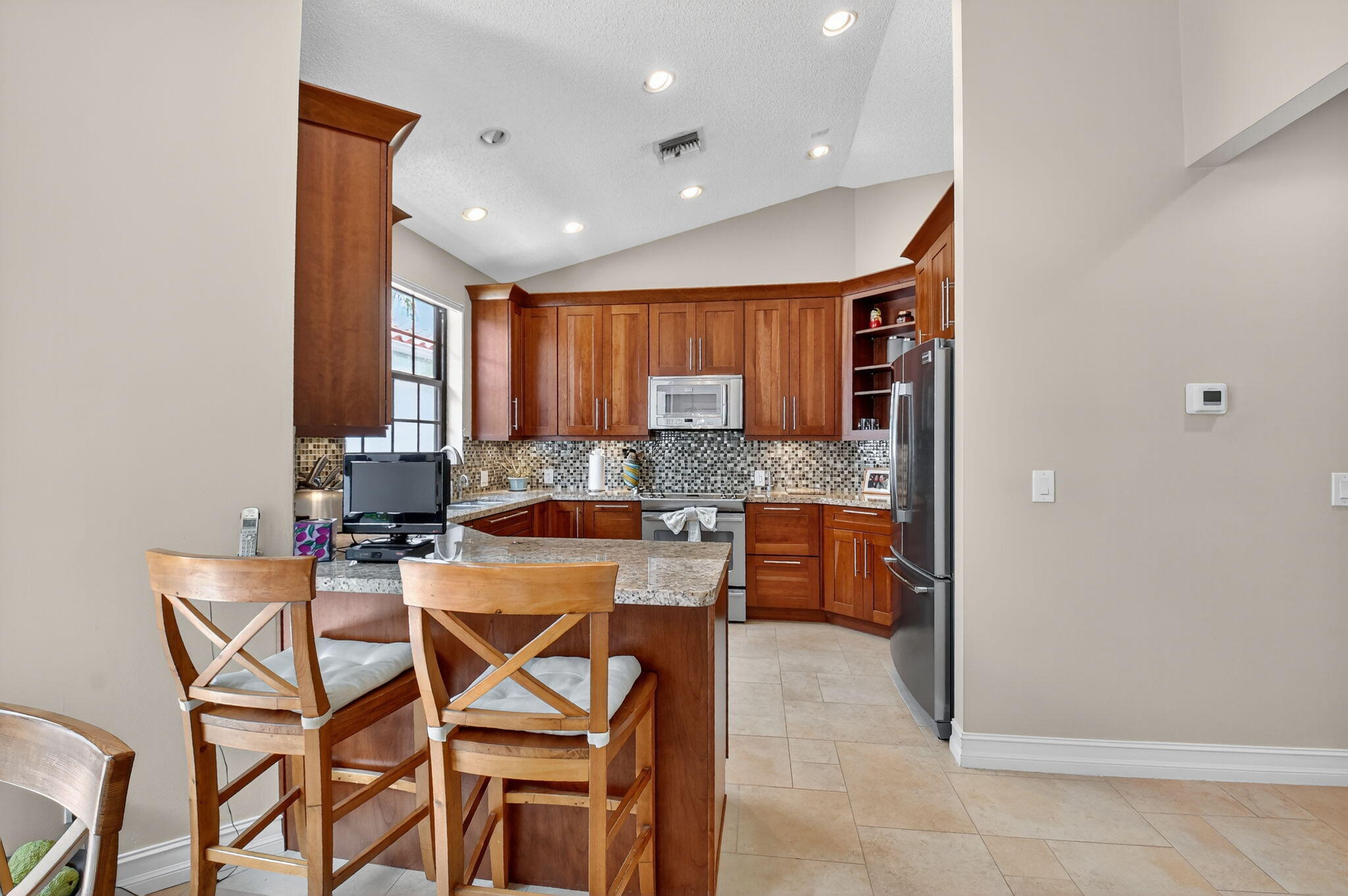 5850 Northwest 21st Avenue Boca Raton, FL 33496 - Photo 17 of 54 a kitchen with a table and chairs in it