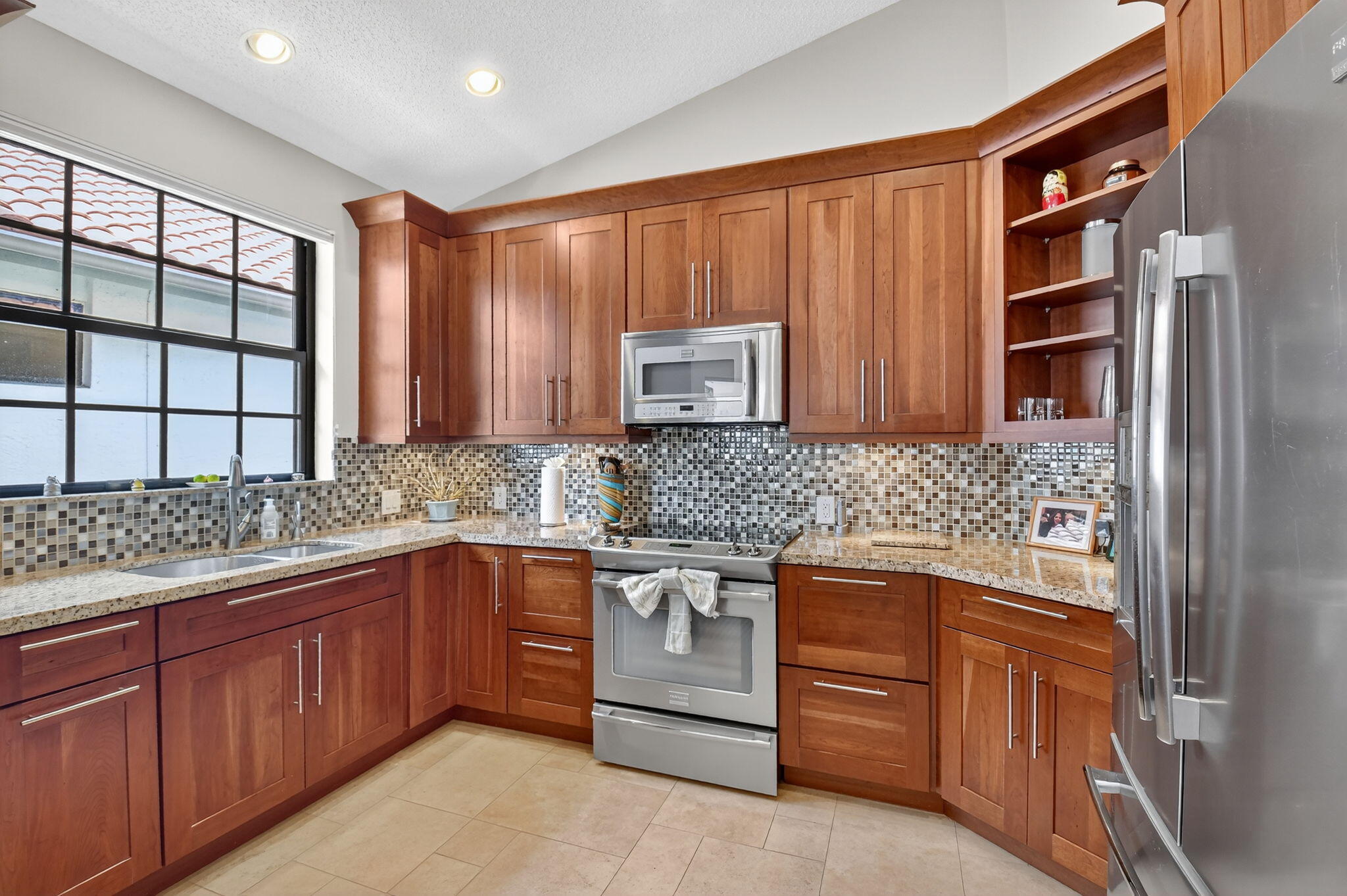 5850 Northwest 21st Avenue Boca Raton, FL 33496 - Photo 19 of 54 a kitchen with stainless steel appliances granite countertop cabinets and window