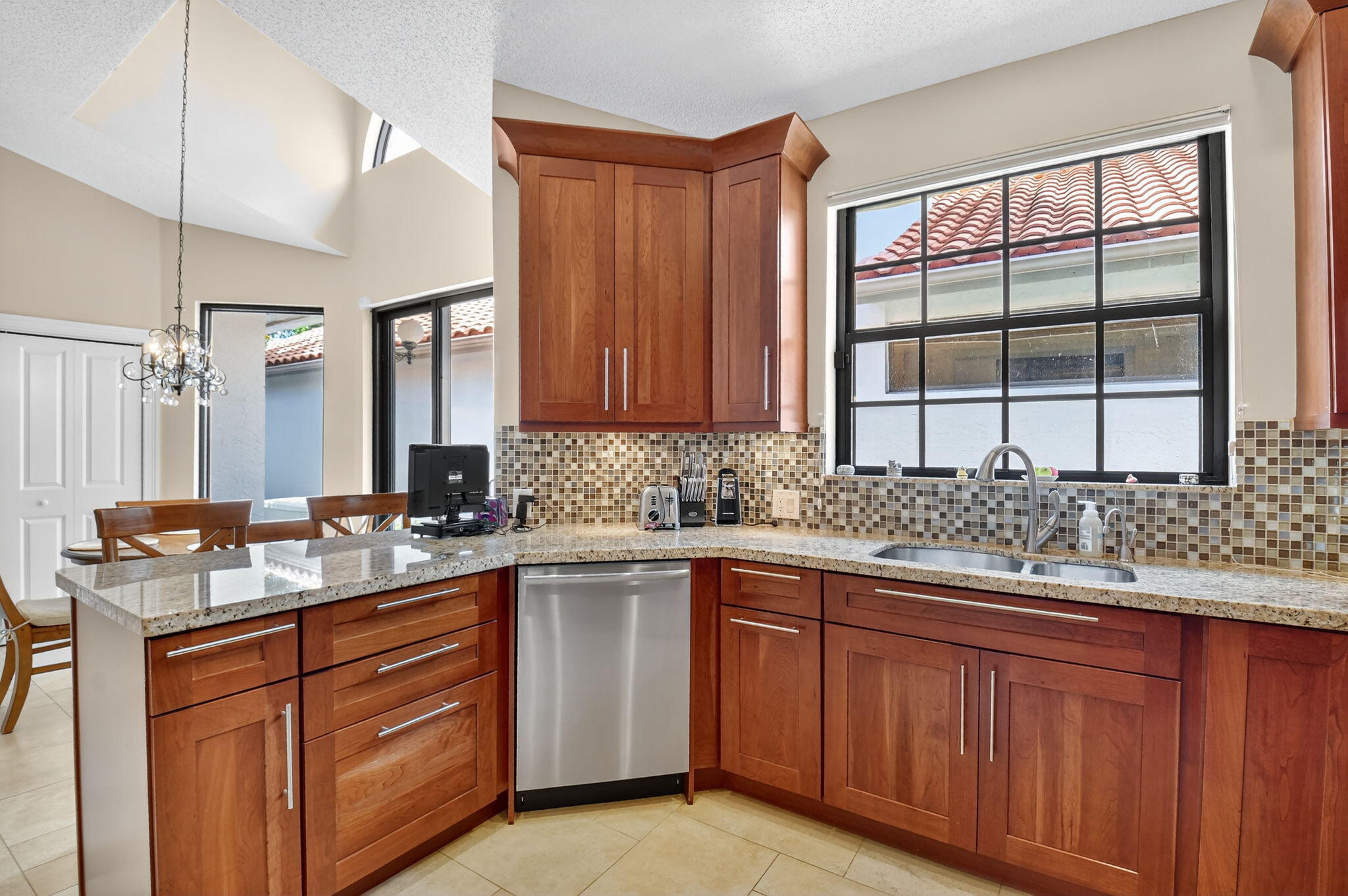 5850 Northwest 21st Avenue Boca Raton, FL 33496 - Photo 20 of 54 a kitchen with a sink and wooden cabinets