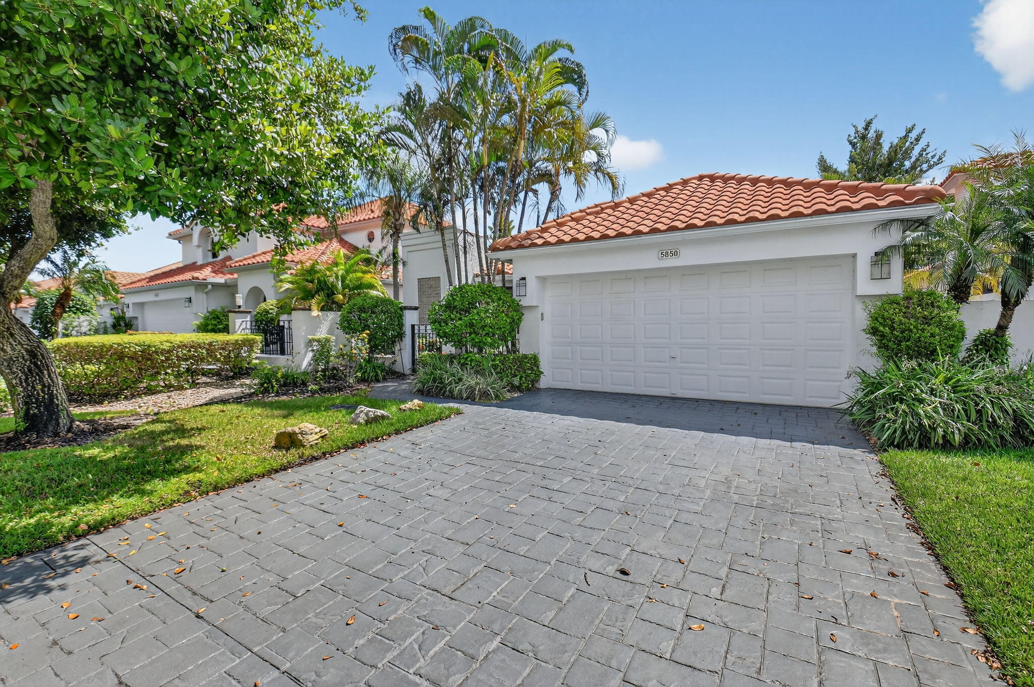 5850 Northwest 21st Avenue Boca Raton, FL 33496 - Photo 2 of 54 a front view of house with yard and green space