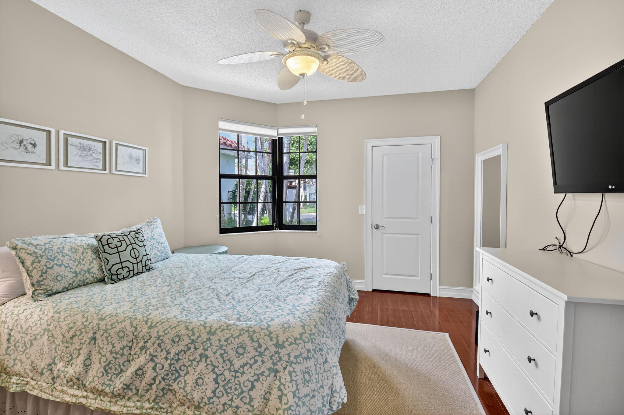 5850 Northwest 21st Avenue Boca Raton, FL 33496 - Photo 28 of 54 a bedroom with a bed and a flat screen tv