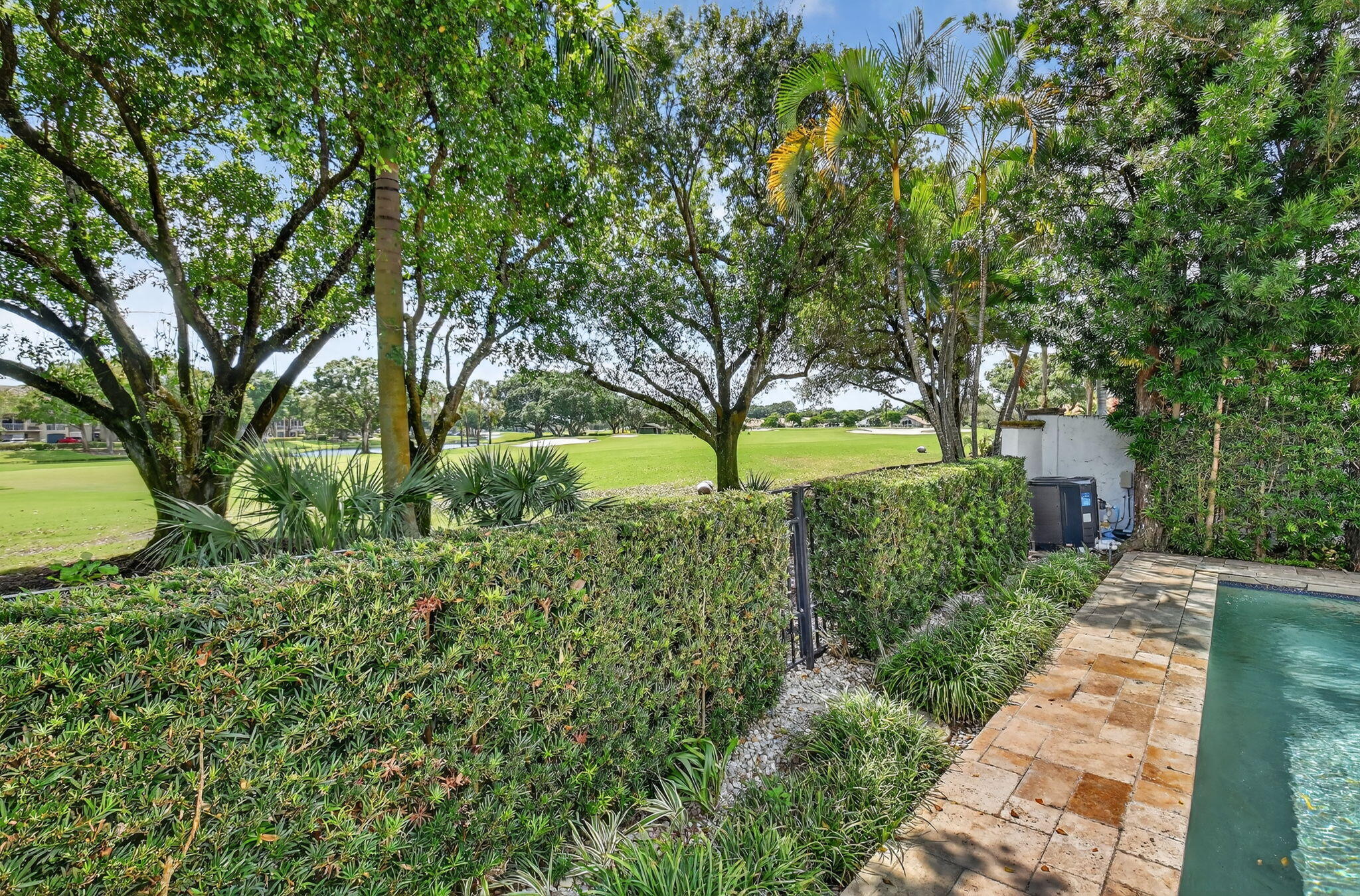 5850 Northwest 21st Avenue Boca Raton, FL 33496 - Photo 35 of 54 a view of a yard with plants and a large tree
