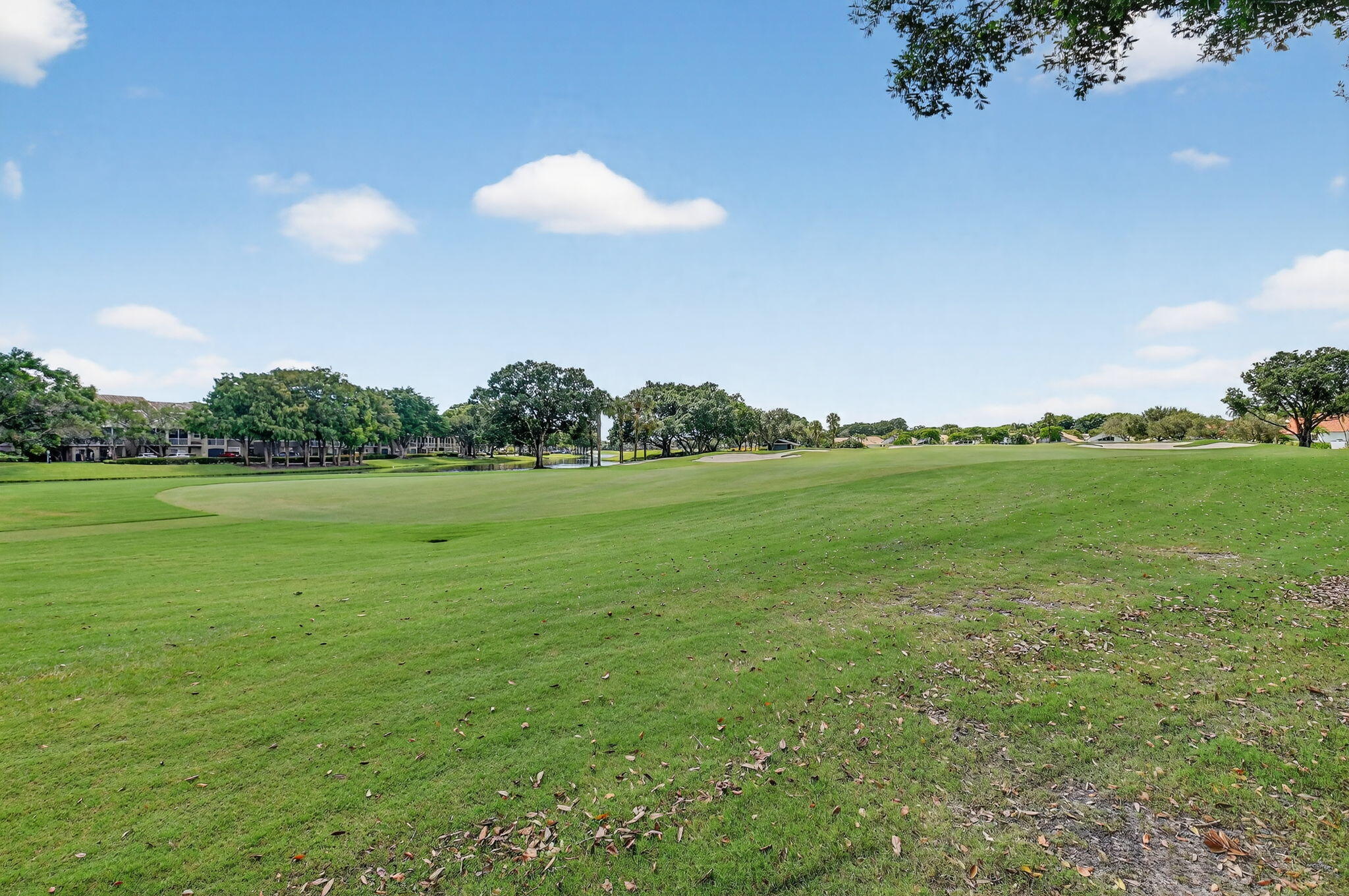 5850 Northwest 21st Avenue Boca Raton, FL 33496 - Photo 42 of 54 a view of a golf course with a lake