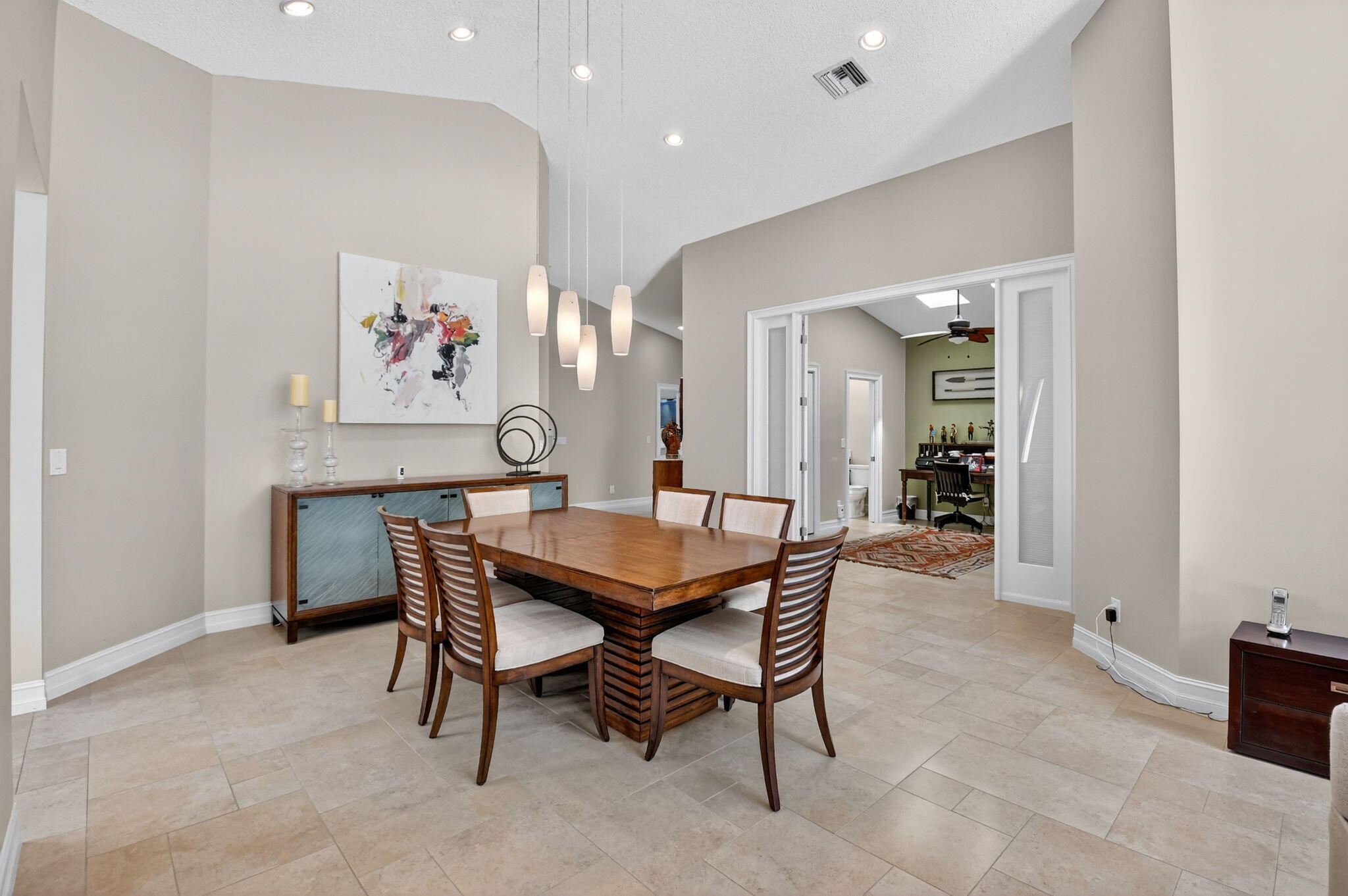 5850 Northwest 21st Avenue Boca Raton, FL 33496 - Photo 7 of 54 a dining room with furniture and a painting on the wall