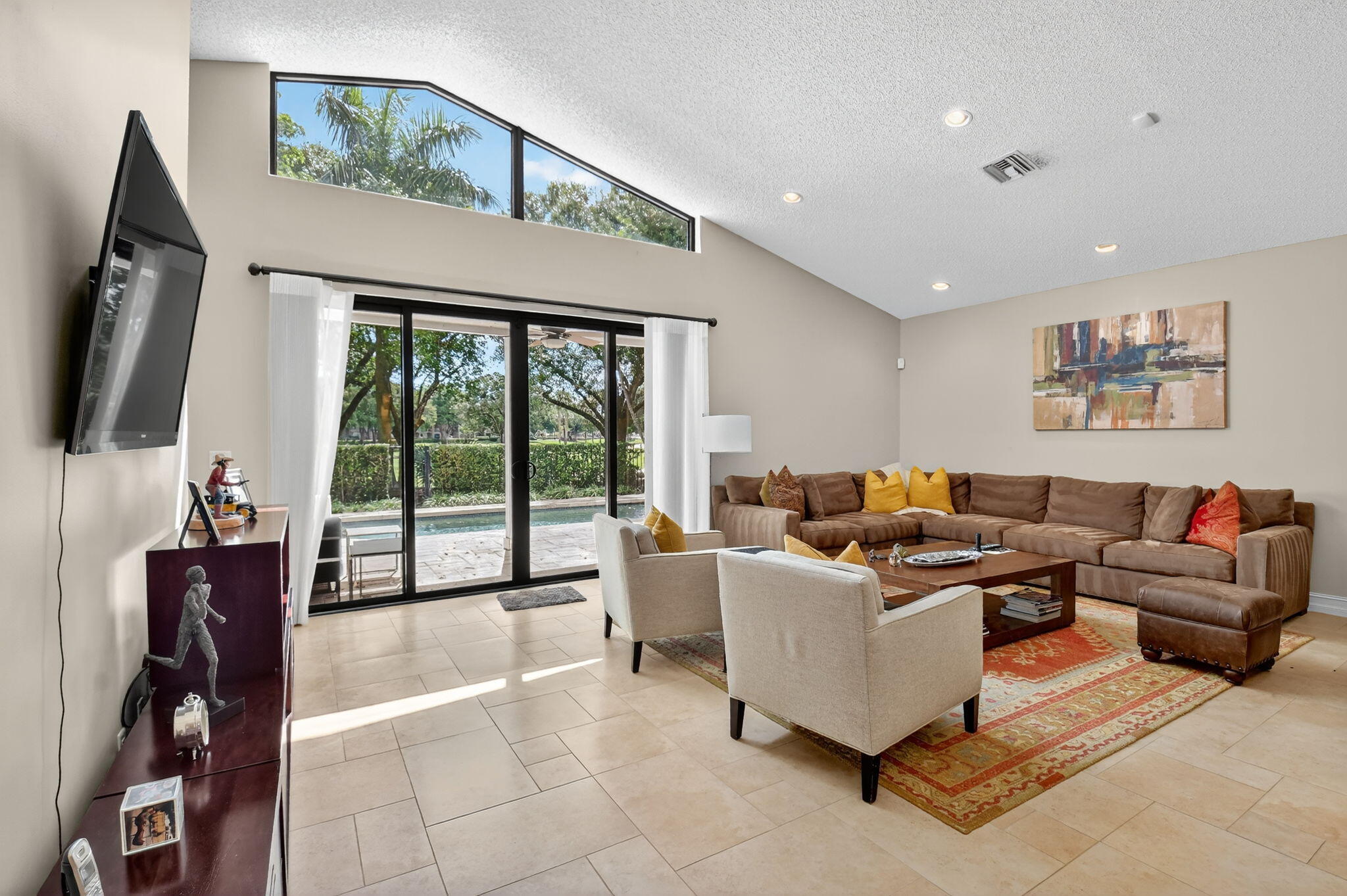 5850 Northwest 21st Avenue Boca Raton, FL 33496 - Photo 10 of 54 a living room with furniture and a flat screen tv