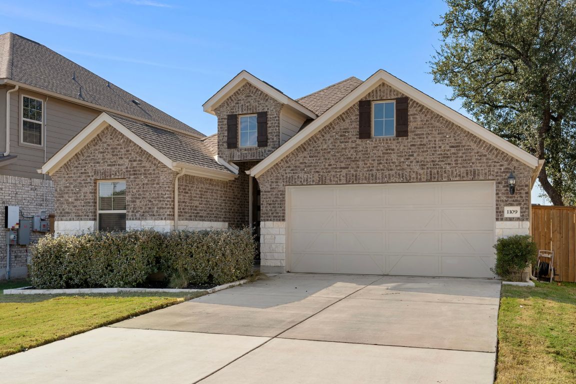 1109 Morning View Road Georgetown, TX 78628 - Photo 1 of 40 a front view of a house with a yard and garage