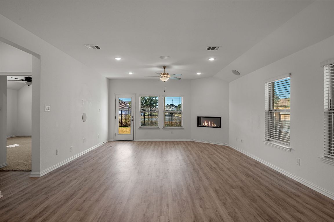 1109 Morning View Road Georgetown, TX 78628 - Photo 8 of 40 a view of an empty room with wooden floor and a window