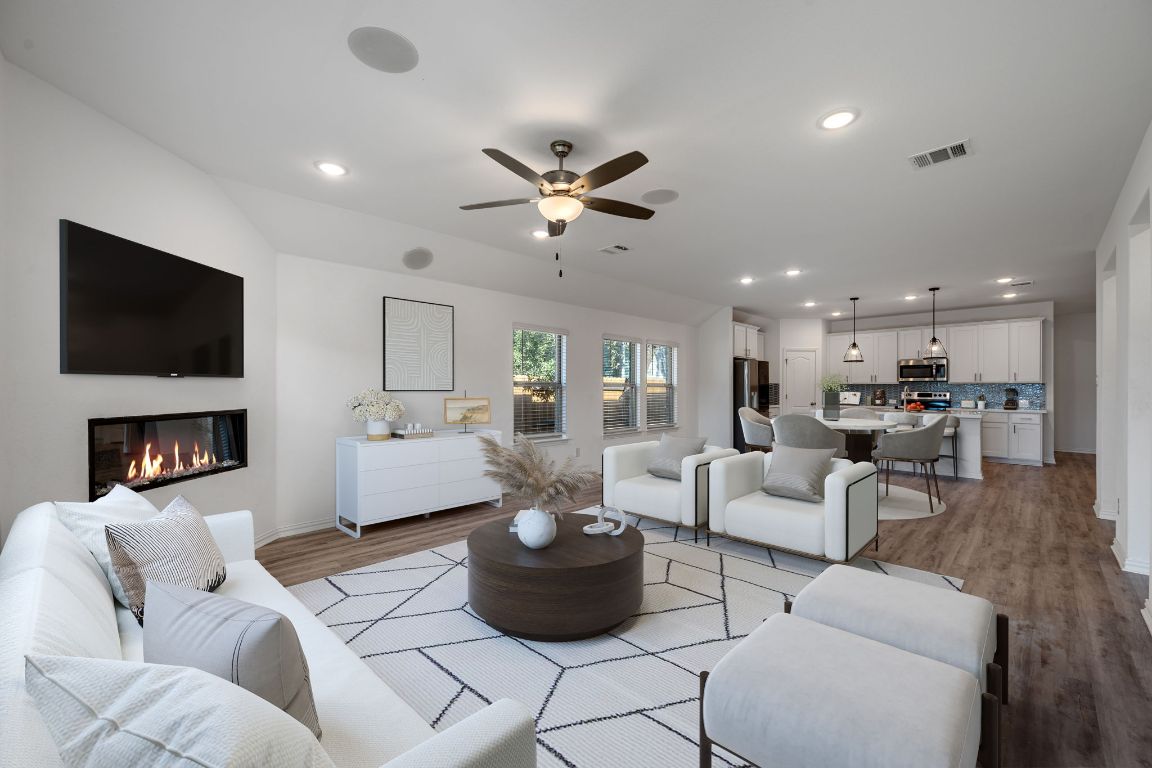 1109 Morning View Road Georgetown, TX 78628 - Photo 9 of 40 a living room with furniture a fireplace and a flat screen tv