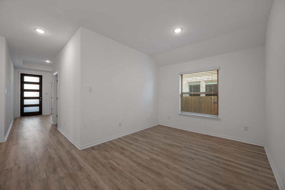 1109 Morning View Road Georgetown, TX 78628 - Photo 12 of 40 wooden floor in an empty room with a window