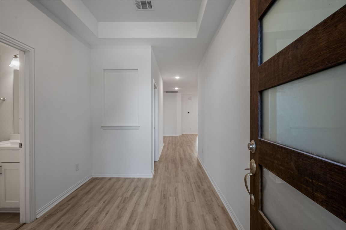 1109 Morning View Road Georgetown, TX 78628 - Photo 2 of 40 a view of a hallway with wooden floor and staircase