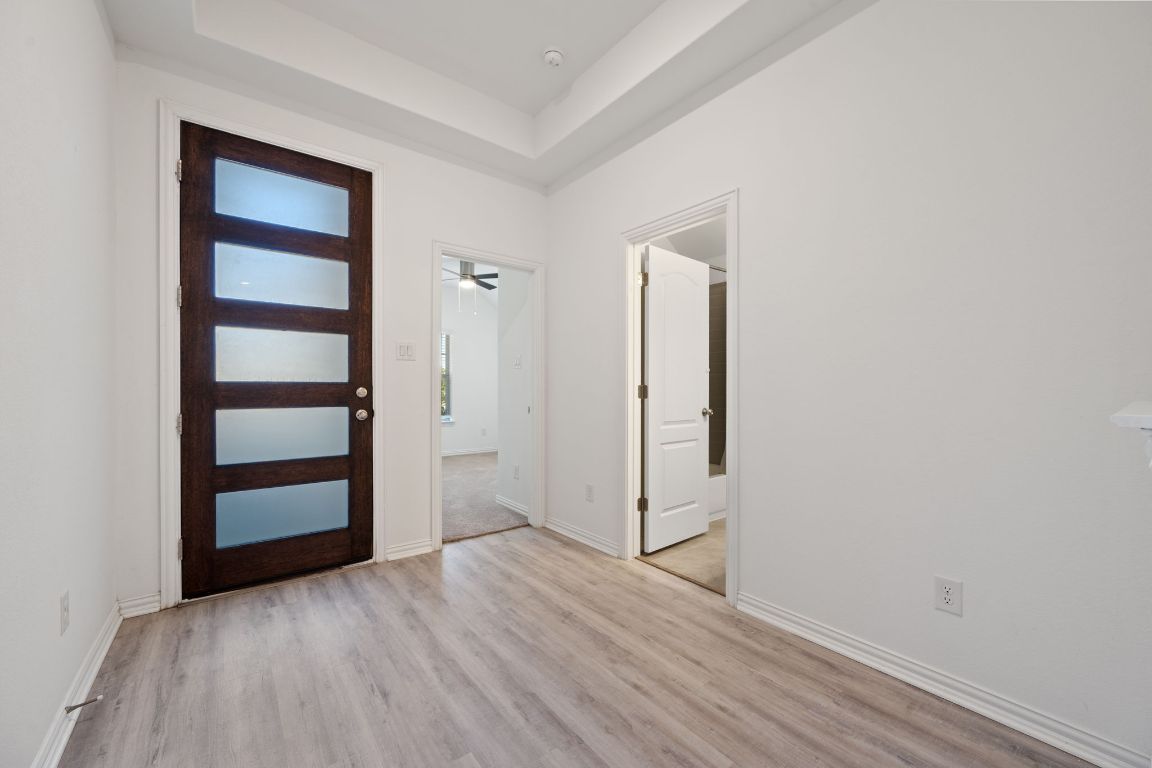 1109 Morning View Road Georgetown, TX 78628 - Photo 22 of 40 an empty room with wooden floor closet and windows