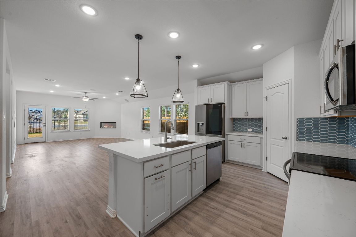 1109 Morning View Road Georgetown, TX 78628 - Photo 3 of 40 a kitchen with stainless steel appliances kitchen island a large island in the center