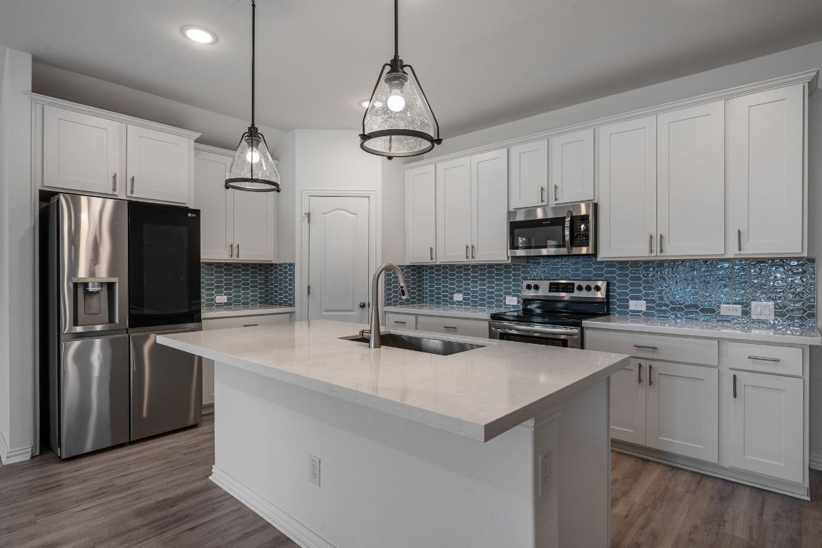 1109 Morning View Road Georgetown, TX 78628 - Photo 5 of 40 a kitchen with stainless steel appliances a refrigerator sink and microwave