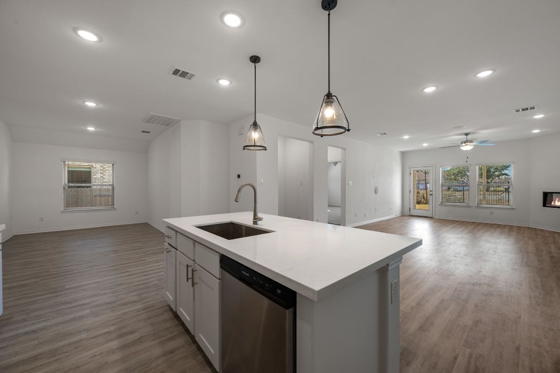 1109 Morning View Road Georgetown, TX 78628 - Photo 38 of 40 a kitchen with a sink a center island wooden floor and a ceiling fan