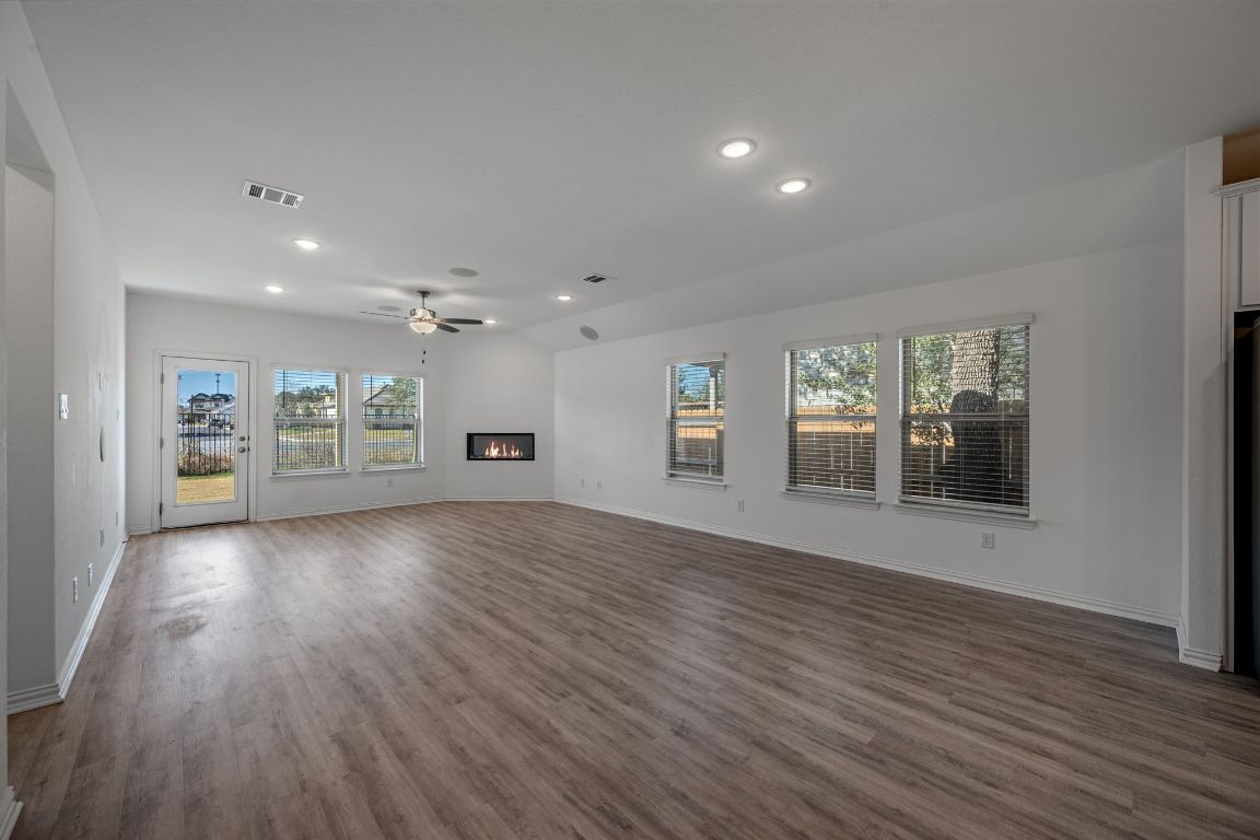 1109 Morning View Road Georgetown, TX 78628 - Photo 6 of 40 a view of an empty room with a window and wooden floor