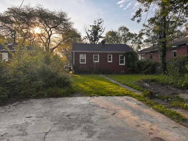 3608 Virginia Street Gary, IN 46409 - Photo 2 of 13 a view of a yard in front of a house with large tree