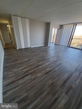 a view of an empty room and wooden floor
