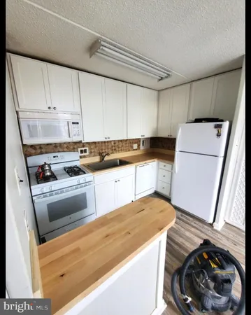 a kitchen with a sink a stove and cabinets