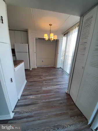 a view of a hallway view with wooden floor and staircase