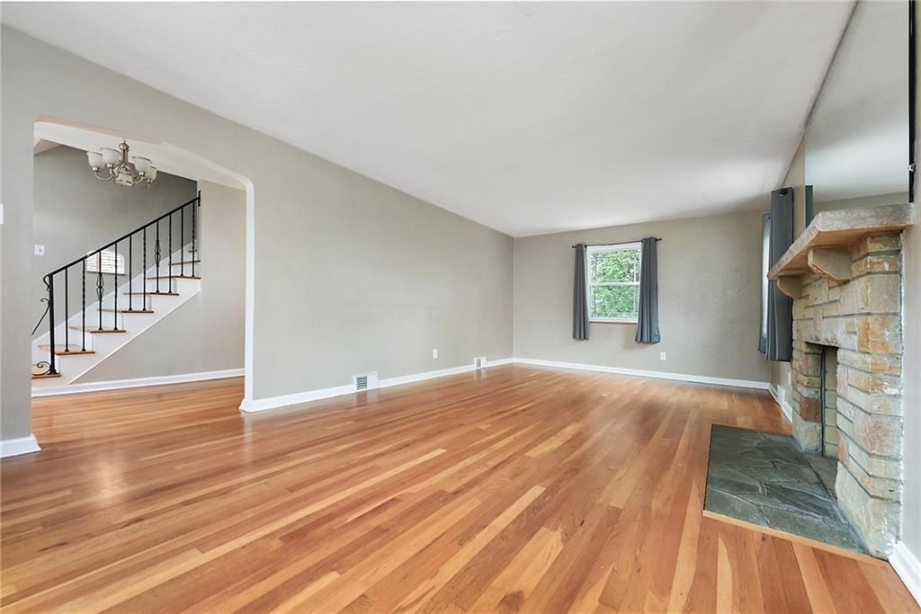 1161 Prospect Road Pittsburgh, PA 15227 - Photo 11 of 39 a view of an empty room with wooden floor and a window