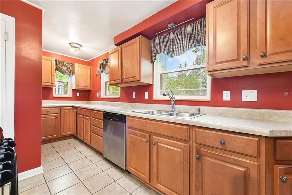 1161 Prospect Road Pittsburgh, PA 15227 - Photo 15 of 39 a kitchen with kitchen island granite countertop a sink window and cabinets
