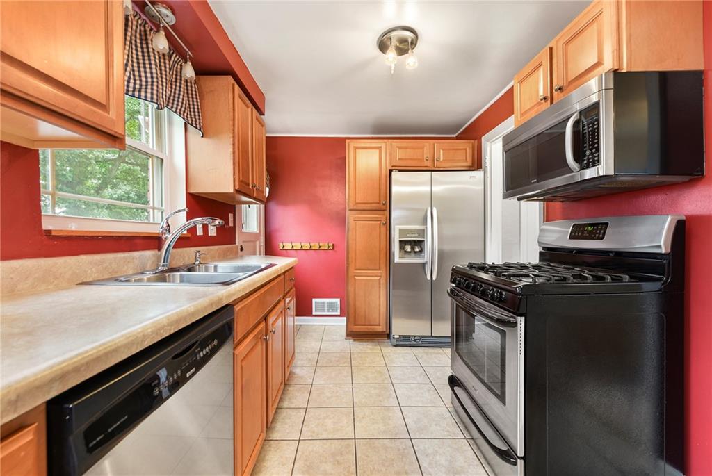 1161 Prospect Road Pittsburgh, PA 15227 - Photo 16 of 39 a kitchen with stainless steel appliances granite countertop a stove and a sink
