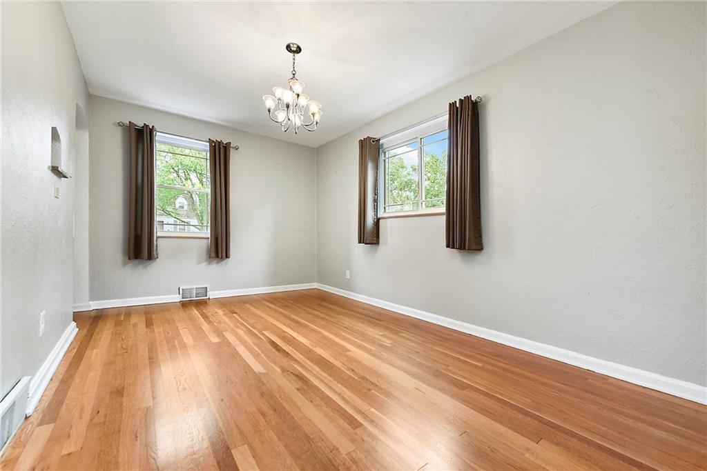 1161 Prospect Road Pittsburgh, PA 15227 - Photo 19 of 39 a view of an empty room with a window and wooden floor