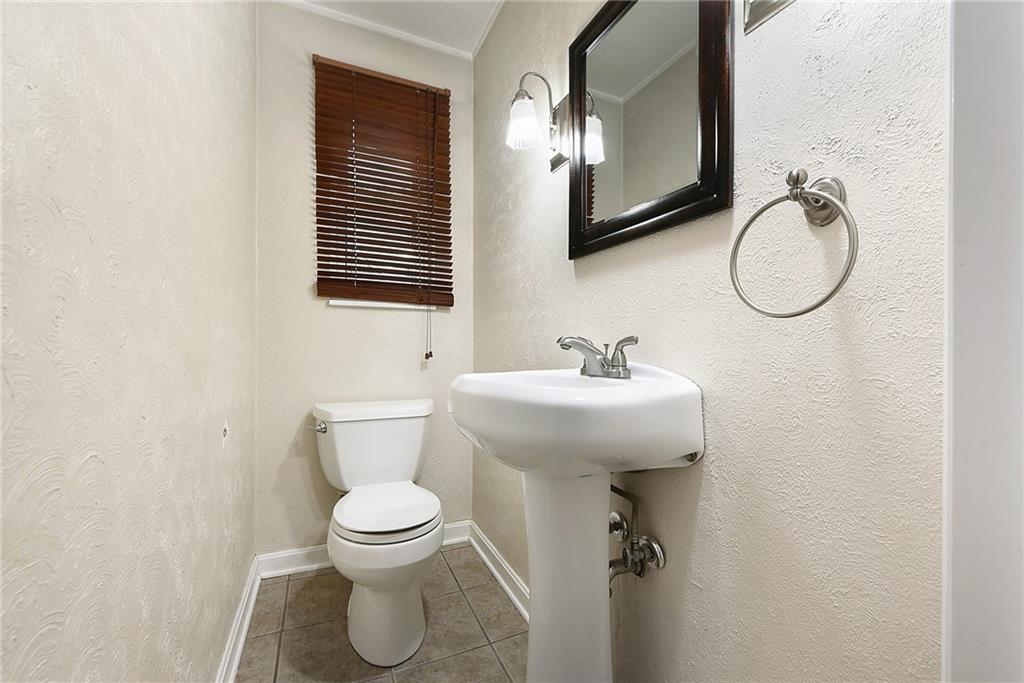 1161 Prospect Road Pittsburgh, PA 15227 - Photo 22 of 39 a bathroom with a toilet sink and mirror