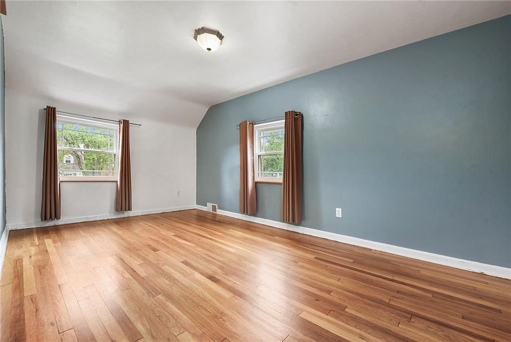 1161 Prospect Road Pittsburgh, PA 15227 - Photo 23 of 39 a view of an empty room with wooden floor and a window