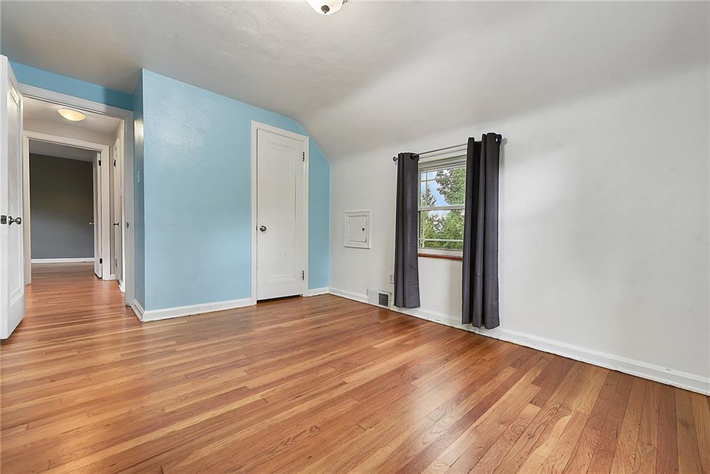 1161 Prospect Road Pittsburgh, PA 15227 - Photo 28 of 39 a view of an empty room with wooden floor and a window