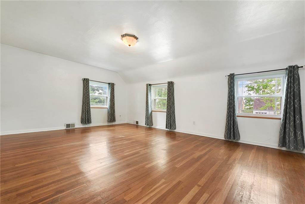 1161 Prospect Road Pittsburgh, PA 15227 - Photo 29 of 39 a view of an empty room with wooden floor and a window
