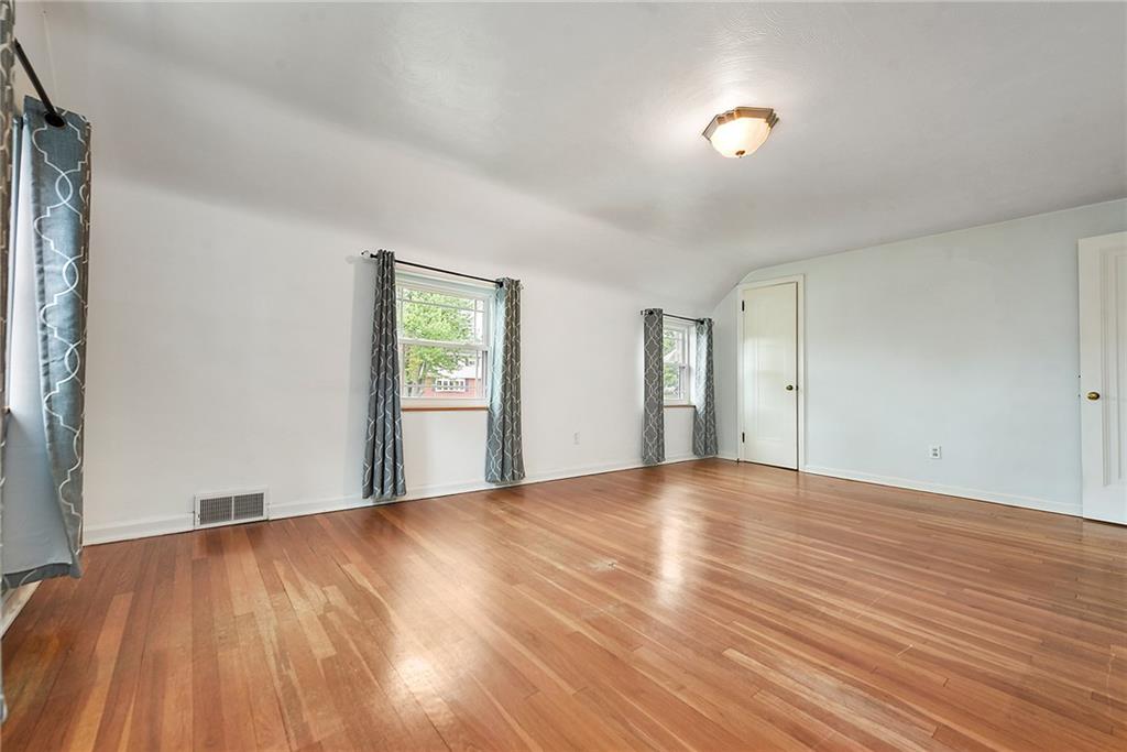 1161 Prospect Road Pittsburgh, PA 15227 - Photo 30 of 39 a view of an empty room with window and wooden floor