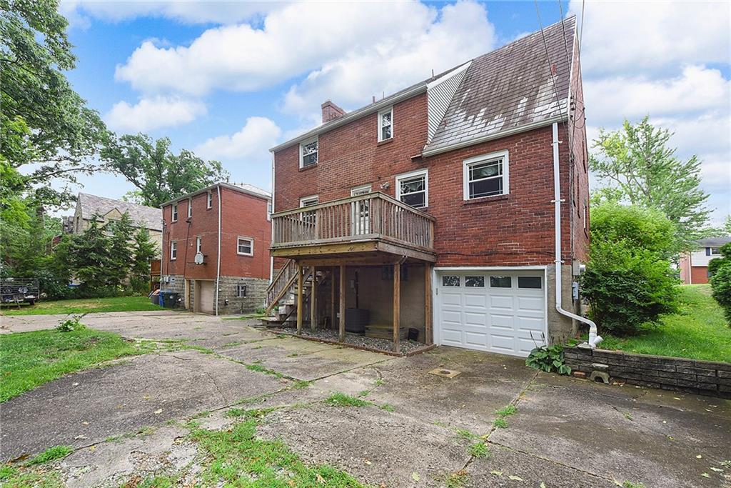 1161 Prospect Road Pittsburgh, PA 15227 - Photo 35 of 39 a front view of a house with a yard and garage