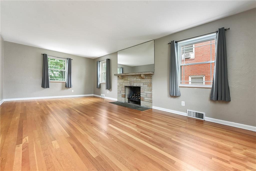 1161 Prospect Road Pittsburgh, PA 15227 - Photo 8 of 39 a view of empty room with wooden floor and fireplace