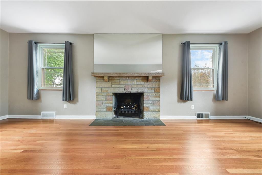 1161 Prospect Road Pittsburgh, PA 15227 - Photo 9 of 39 a view of a livingroom with wooden floor and a fireplace