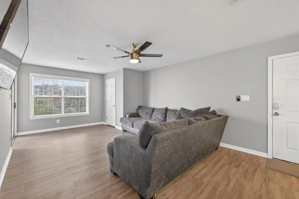 a living room with furniture and a large window