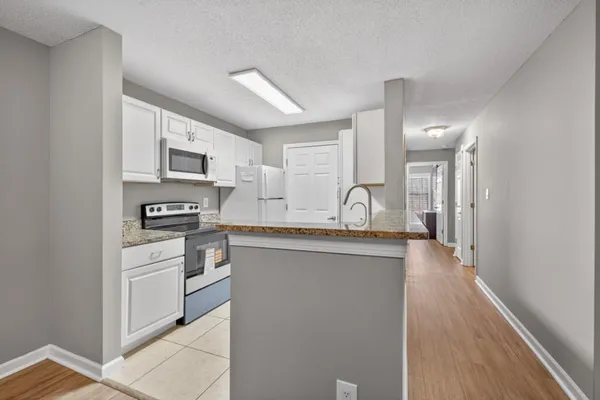 a kitchen with cabinets a sink and appliances