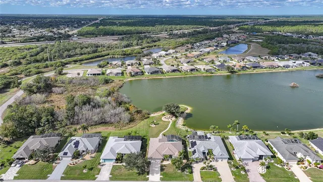 an aerial view of a house with a swimming pool yard and outdoor seating