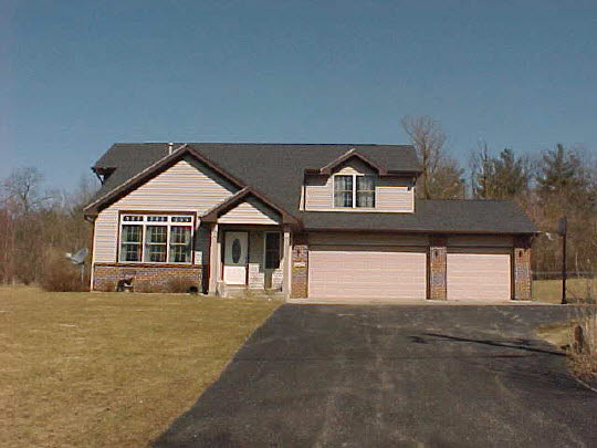 8188 Mcmichael Road Caledonia, IL 61011 - Photo 1 of 6 a front view of a house with a yard and garage