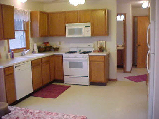 8188 Mcmichael Road Caledonia, IL 61011 - Photo 4 of 6 a kitchen with a sink stove and refrigerator