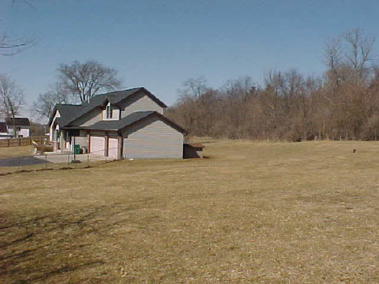 8188 Mcmichael Road Caledonia, IL 61011 - Photo 6 of 6 a front view of a house with a yard