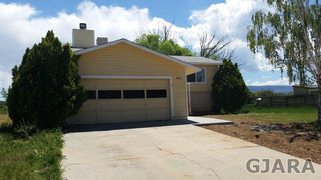 2945 El Torro Road Grand Junction, CO 81503 - Photo 1 of 1 a front view of a house with garden